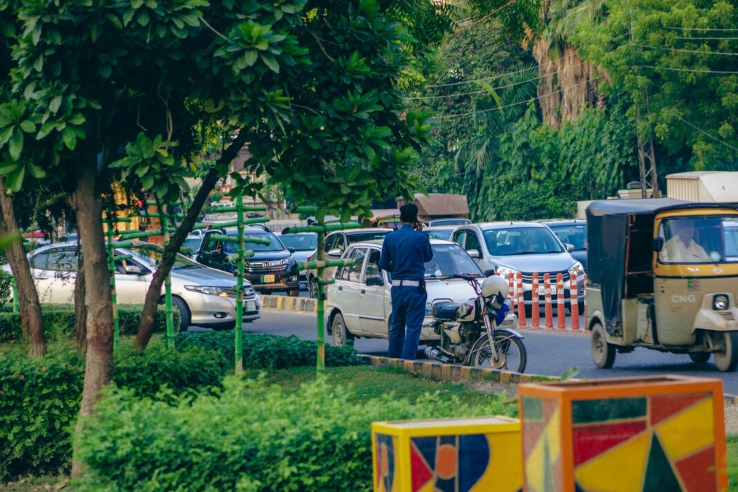 policeman talking on the phone while standing on the street